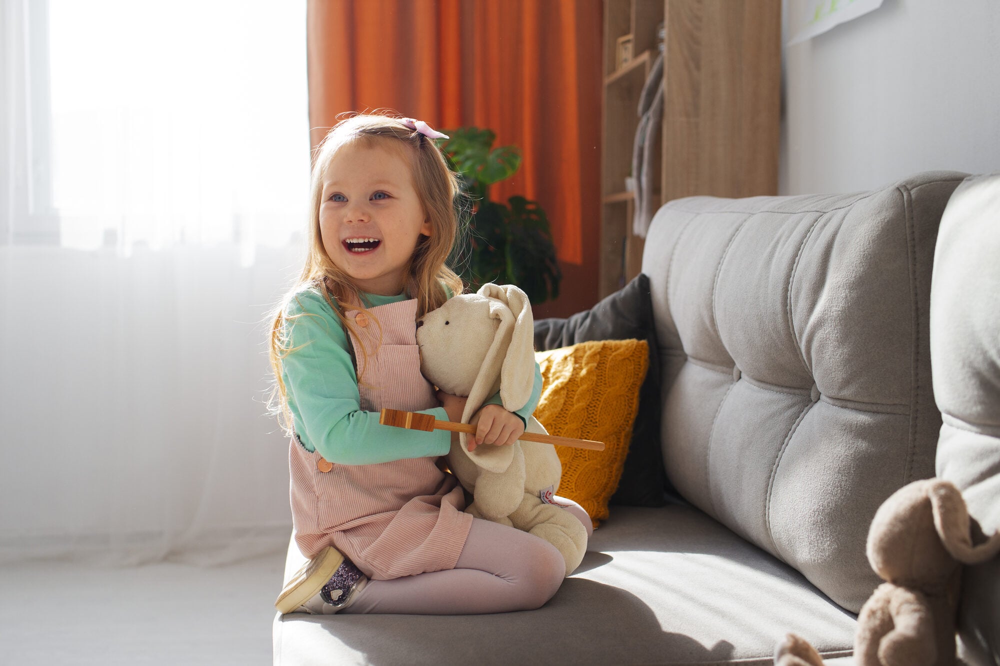 A young girl playing happily at home