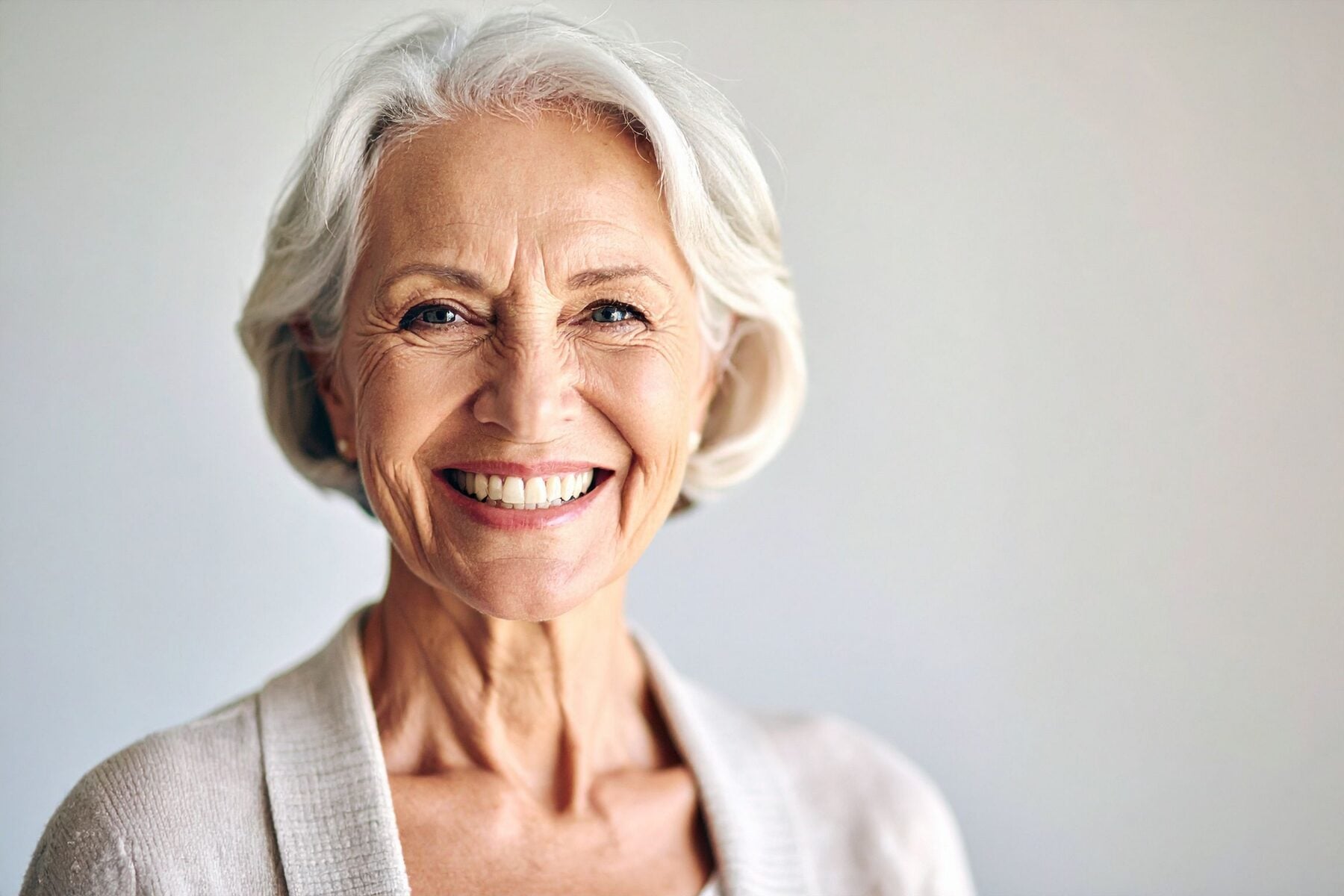 An older woman with silver hair smiling warmly